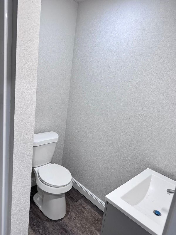 bathroom with vanity, hardwood / wood-style floors, and toilet