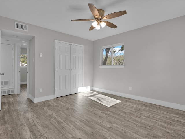 unfurnished bedroom featuring a closet, ceiling fan, and light wood-type flooring