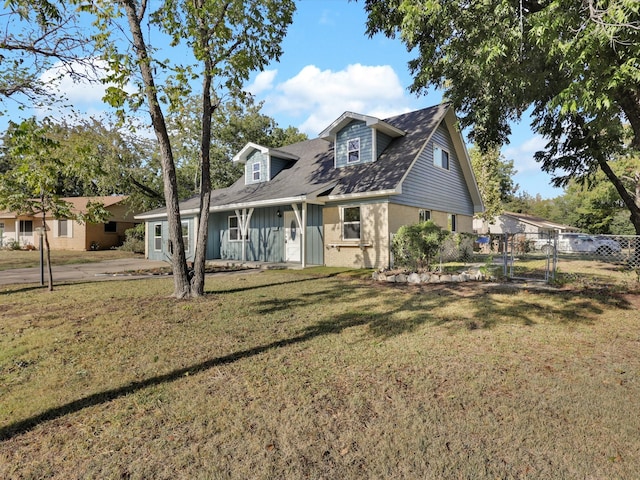 cape cod home with a front yard