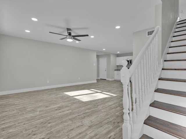 interior space featuring light hardwood / wood-style floors and ceiling fan