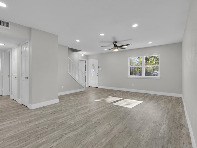 unfurnished living room featuring light hardwood / wood-style flooring and ceiling fan