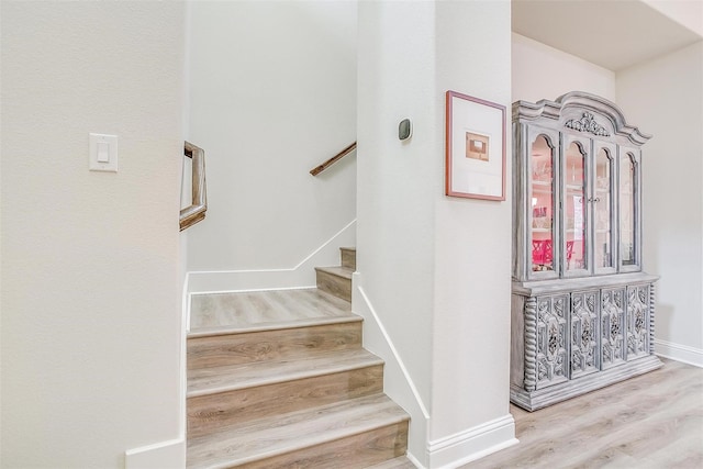 stairs with wood-type flooring