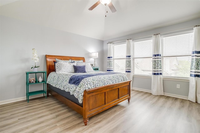 bedroom with ceiling fan, lofted ceiling, and light hardwood / wood-style flooring