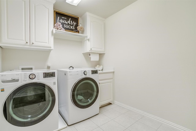 laundry room with separate washer and dryer, light tile patterned floors, and cabinets