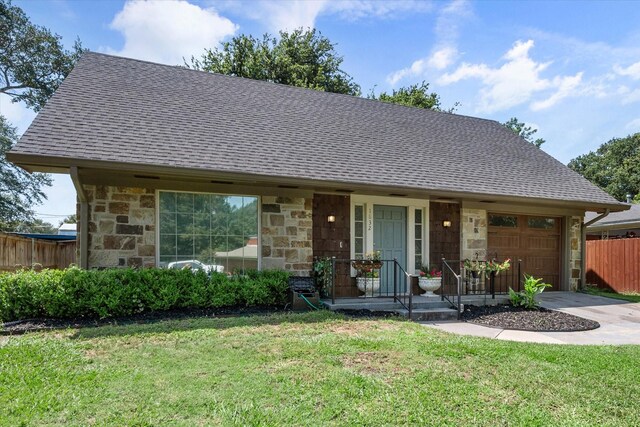 ranch-style home with a front yard and a garage