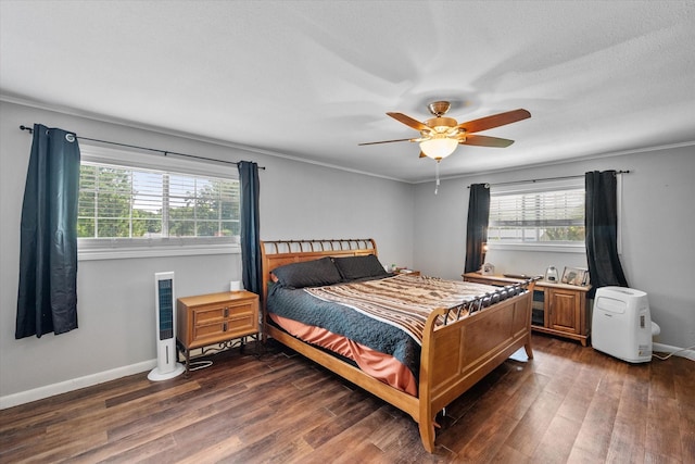 bedroom featuring multiple windows, dark hardwood / wood-style flooring, and ceiling fan