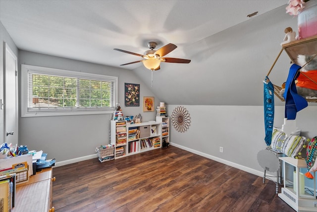 game room with ceiling fan, dark wood-type flooring, and lofted ceiling