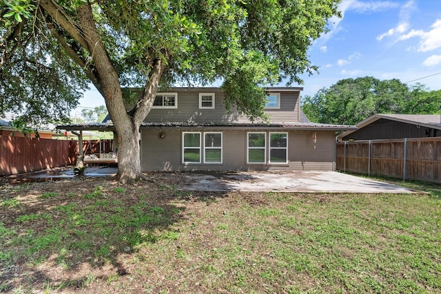 back of house featuring a patio area and a yard