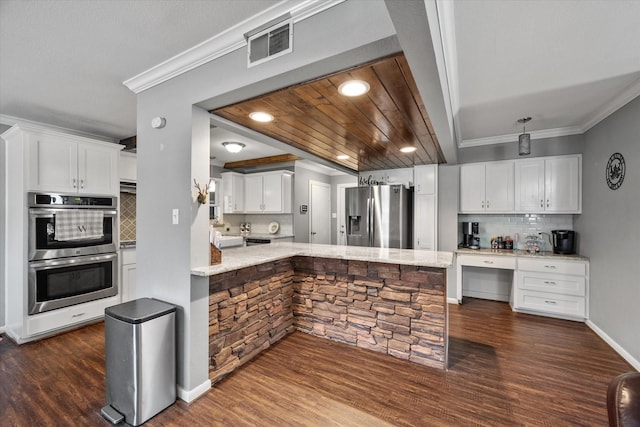 kitchen featuring decorative backsplash, white cabinets, and stainless steel appliances