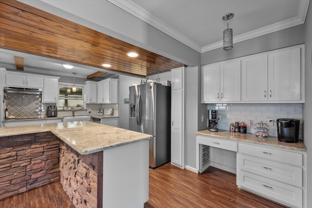 kitchen with backsplash, pendant lighting, and stainless steel refrigerator with ice dispenser