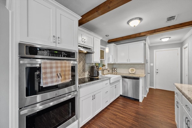 kitchen featuring white cabinets, decorative backsplash, and stainless steel appliances