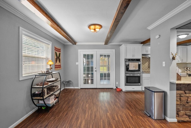 interior space featuring french doors, decorative backsplash, stainless steel double oven, light stone counters, and white cabinetry