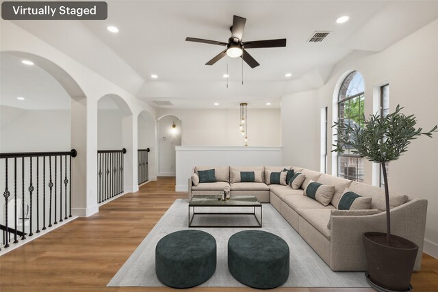 living room featuring light hardwood / wood-style floors and ceiling fan