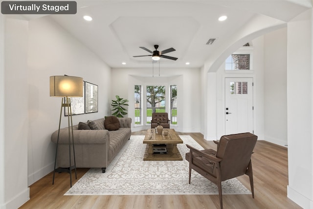 living room featuring light wood-type flooring and ceiling fan