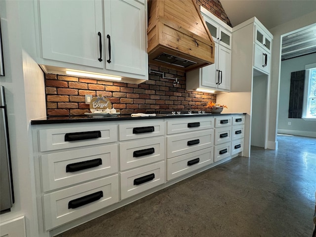 166 Oak Ridge Loop, Whitney, TX 76692 - kitchen featuring custom exhaust hood, dark countertops, concrete flooring, white cabinets, and glass insert cabinets
