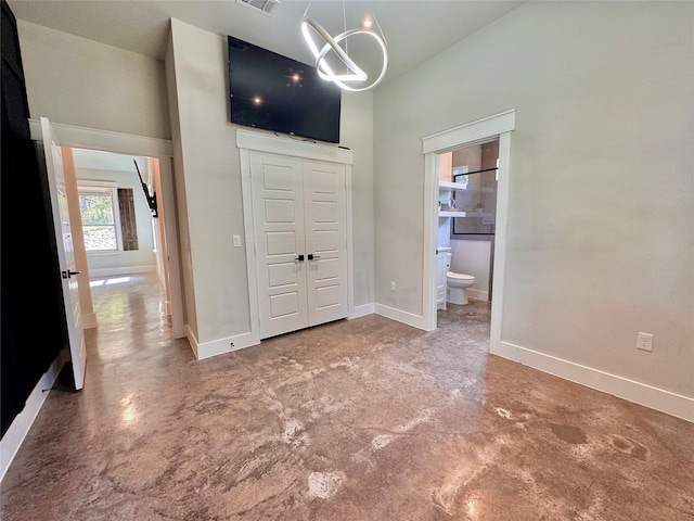 166 Oak Ridge Loop, Whitney, TX 76692 - unfurnished bedroom with concrete flooring, a high ceiling, baseboards, connected bathroom, and a closet
