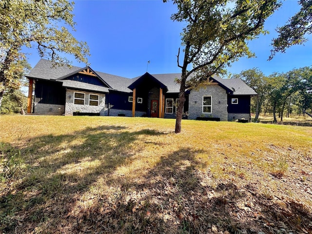 166 Oak Ridge Loop, Whitney, TX 76692 - back of house featuring stone siding and a lawn