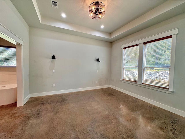 166 Oak Ridge Loop, Whitney, TX 76692 - spare room featuring concrete floors, a raised ceiling, baseboards, and recessed lighting