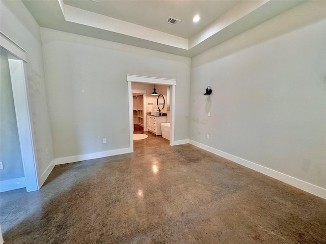 166 Oak Ridge Loop, Whitney, TX 76692 - spare room with finished concrete flooring, a tray ceiling, and baseboards