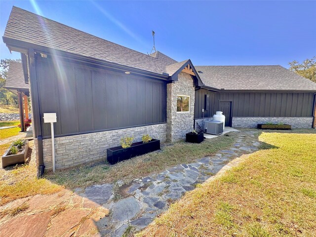 view of home's exterior featuring a yard and cooling unit