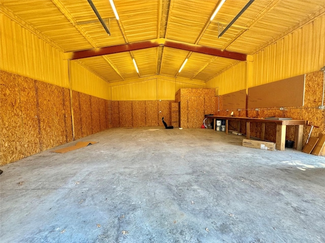 166 Oak Ridge Loop, Whitney, TX 76692 - miscellaneous room with lofted ceiling, a garage, and concrete flooring