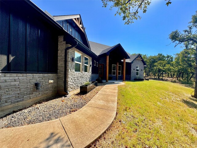 view of side of property with a yard