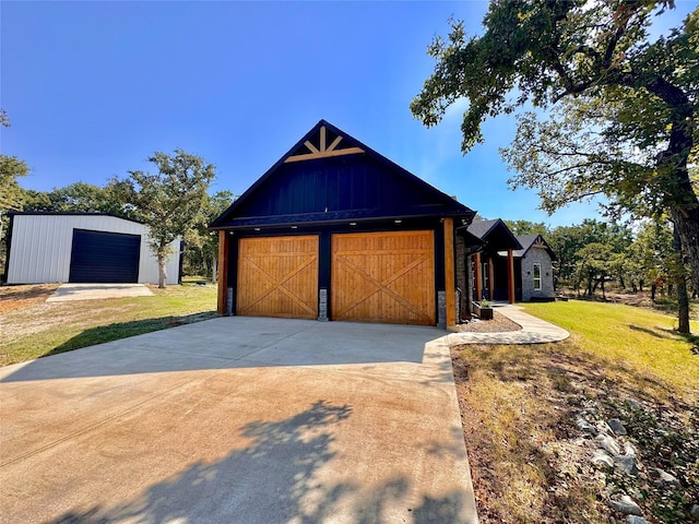 166 Oak Ridge Loop, Whitney, TX 76692 - view of front facade with a garage, a front lawn, driveway, and an outbuilding