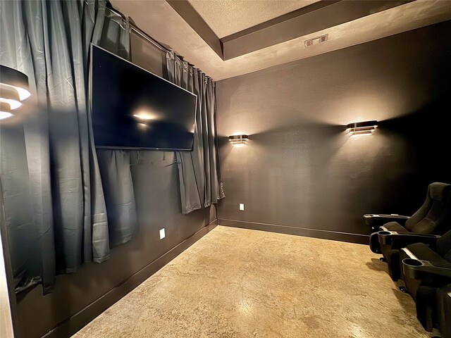 home theater room featuring a textured ceiling