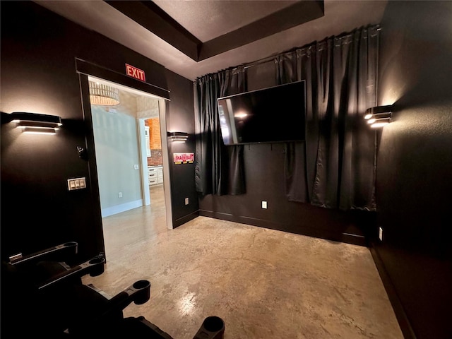 166 Oak Ridge Loop, Whitney, TX 76692 - cinema with a raised ceiling, concrete flooring, and baseboards