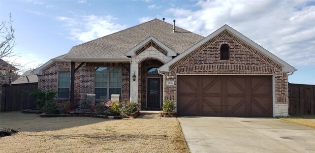 view of front of home with a garage and a front lawn