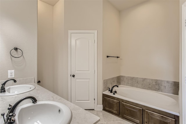 bathroom with vanity, tile patterned floors, and a tub