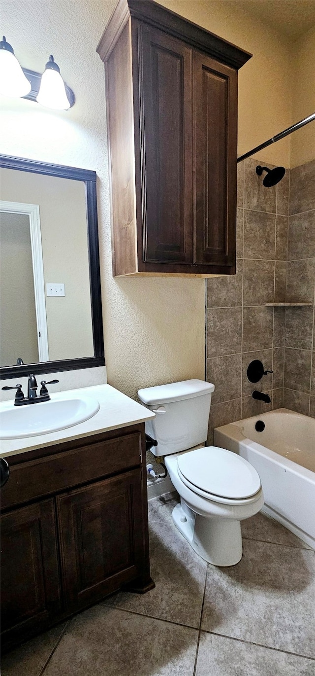 full bathroom with toilet, vanity, tile patterned floors, and tiled shower / bath combo