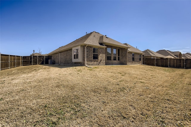 rear view of property with a yard and a patio