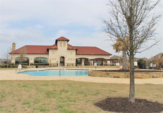 view of pool featuring a patio and a lawn