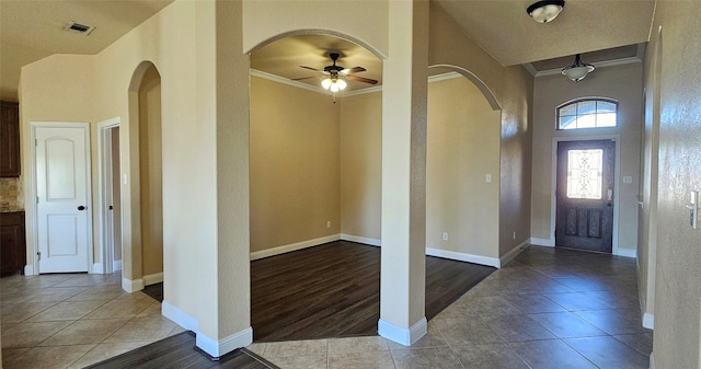 foyer entrance with ceiling fan, light hardwood / wood-style flooring, and ornamental molding