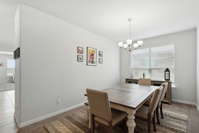 dining area featuring light carpet and a chandelier