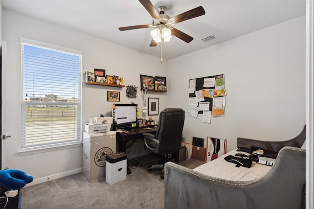 office space featuring light carpet and ceiling fan