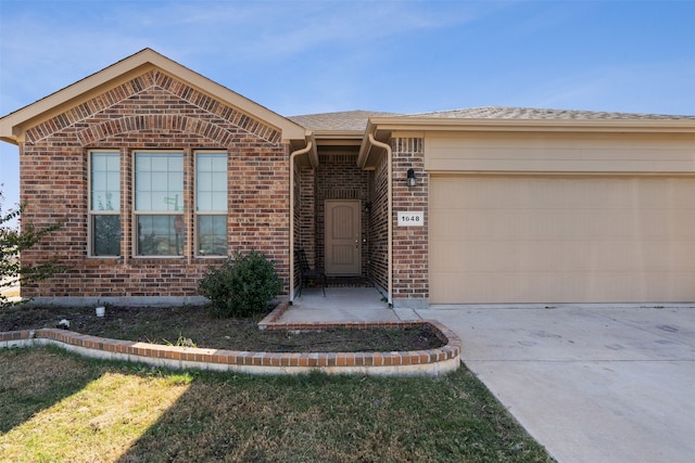 ranch-style home featuring a front yard and a garage