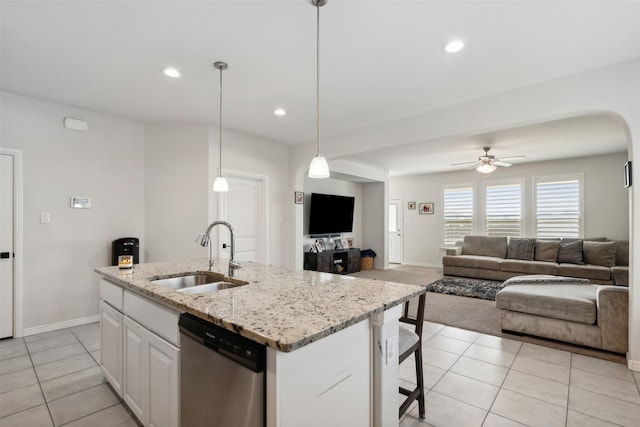 kitchen with dishwasher, a kitchen island with sink, sink, decorative light fixtures, and white cabinets