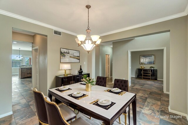 dining room featuring visible vents, crown molding, baseboards, and an inviting chandelier