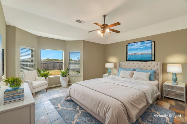 bedroom with a ceiling fan, tile patterned flooring, and visible vents