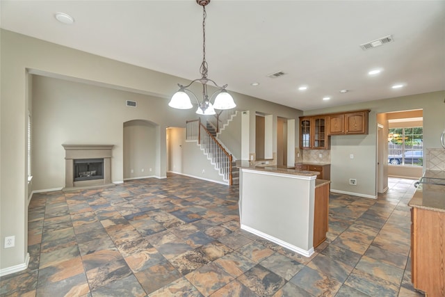 kitchen featuring backsplash, decorative light fixtures, and a chandelier