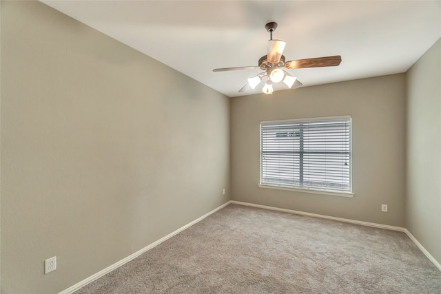 empty room featuring light carpet and ceiling fan