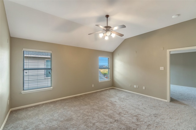 carpeted empty room with lofted ceiling and ceiling fan