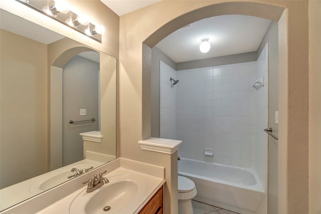 full bathroom with vanity, tiled shower / bath combo, toilet, and tile patterned floors