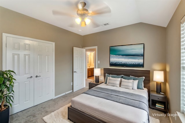 carpeted bedroom featuring lofted ceiling, a closet, visible vents, a ceiling fan, and baseboards