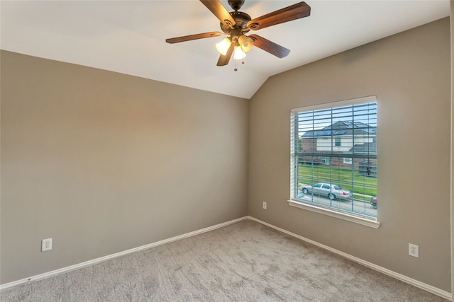 unfurnished room with ceiling fan, baseboards, vaulted ceiling, and light colored carpet