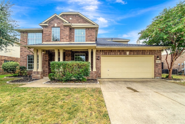 view of front of house with a front yard, brick siding, driveway, and an attached garage