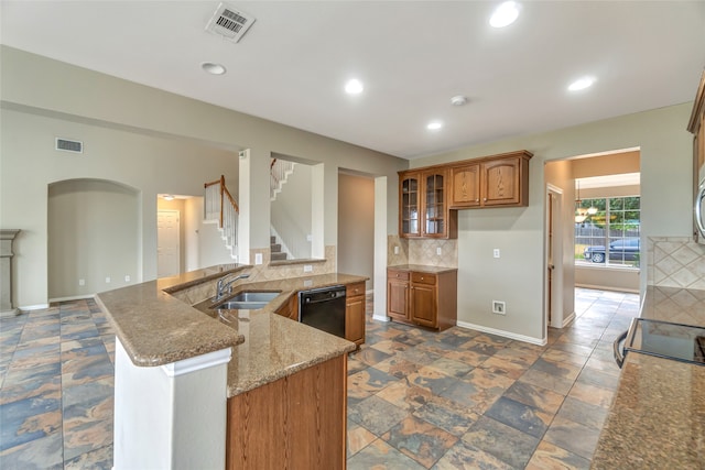 kitchen featuring black dishwasher, a sink, visible vents, and brown cabinets