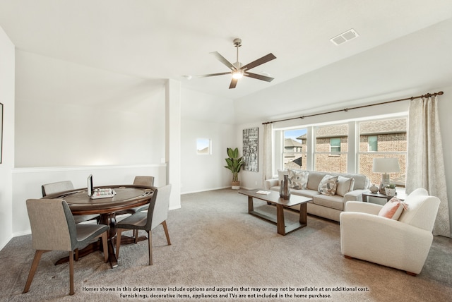 living room with ceiling fan, vaulted ceiling, and light colored carpet